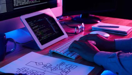 Close-up image of programmer working at his desk in office